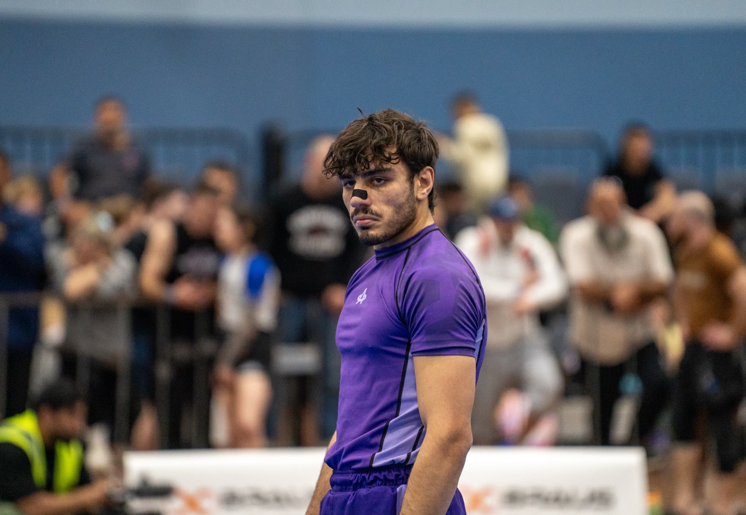 Nationals, Melbourne, an athlete in a purple rashguard looking back over his shoulder
